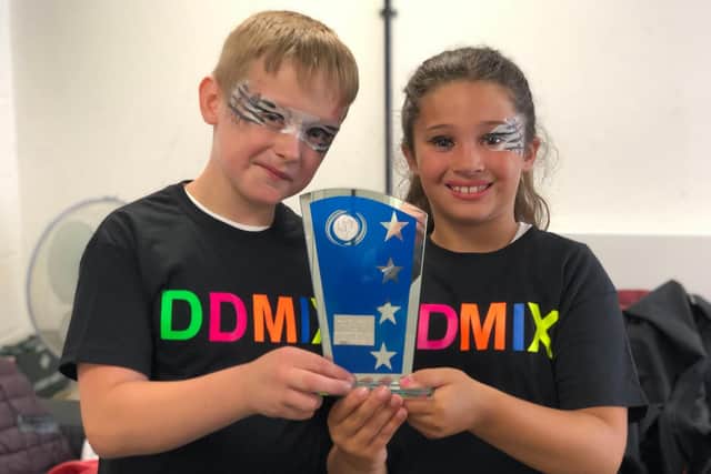 Joseph Urquhart and Cazayah Sterling O'Sullivan, from St George's Beneficial Church of England Primary School, with their trophy for winning Dame Darcey Bussell's Diverse Dance Mix contest at the New Theatre Royal in Portsmouth. Picture: Byron Melton