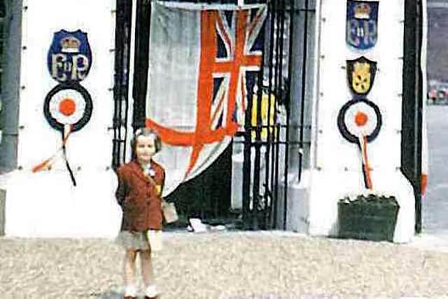 The picture of the gate to Victoria Barracks with Celia Clark in her Brownie uniform.