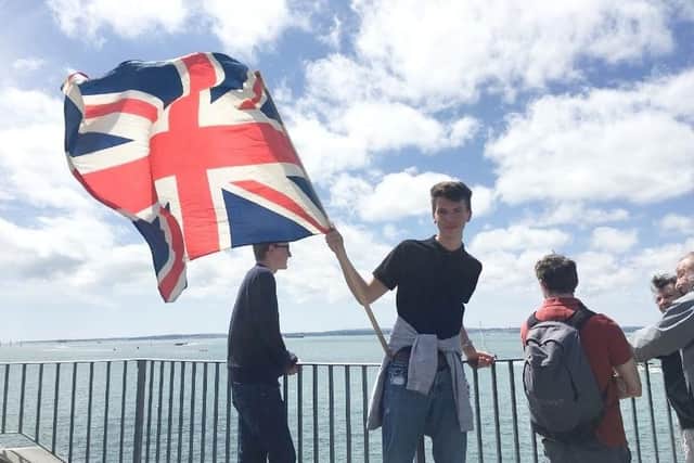 Marcus White waves off the HMS Queen Elizabeth carrier, as she sets sail for a fresh round of sea trials. Picture: Louisa Moth