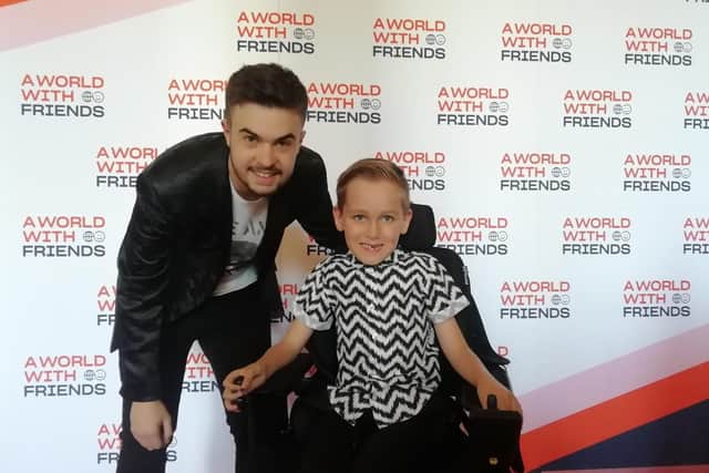 Lewis Hine, left, with seven-year-old Archie Kambanis, from Northampton, at the annual A World With Friends prom at Portsmouth Guildhall. Picture: David George