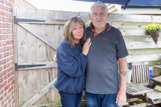 David Nevett with his wife, Penny, near the rear gate of their house where the burglar made his escape. Picture: Habibur Rahman