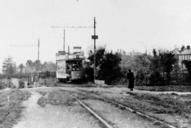 With Queen Alexandra Hospital peeking over the hedgerow, a tram passes over Southwick Hill Road. Picture: Barry Cox postcard collection