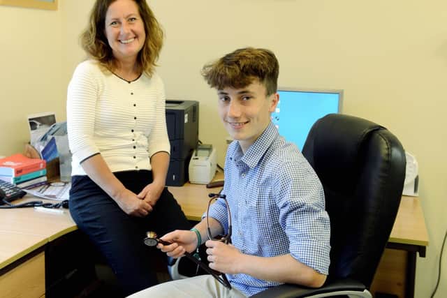George Ashby, 16 with his mother Amelia who is a GP at the Lavant Road surgery in Lavant