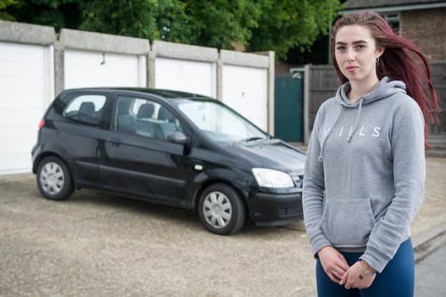 Army reservist Charli Wheatley, 18, was left devastated after her car was targeted and a dead badger was left on the bonnet. Pictured: Charli Wheatley near her now clean car at her home in Denmead. Picture: Habibur Rahman