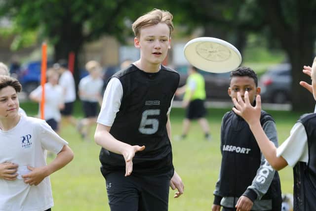 From left, Sydney Raeside, Jasper Cox and Ahmed Fadlalla during ultimate frisbee. Picture: Sarah Standing (200619-1113)