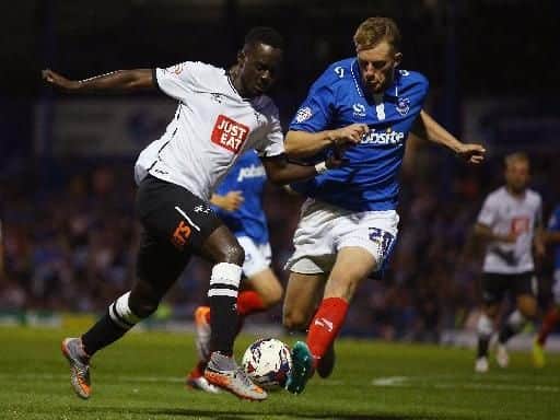 Matt Clarke of Portsmouth tries to tackle Simon Dawkins of Derby County during the Capital One Cup First Round match between Portsmouth v Derby County at Fratton Park on August 12, 2015