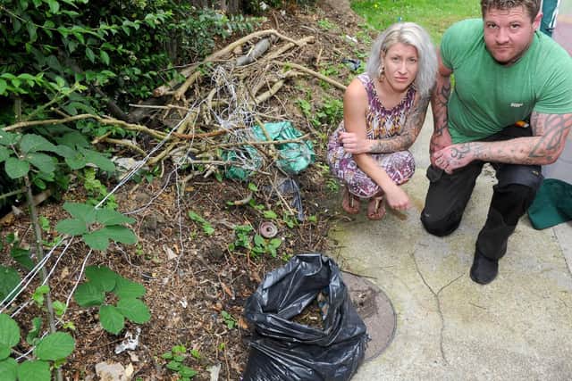 Roy Martin (36) with his partner Michelle Egan (32) next to the drain which has been clogging up. Picture: Sarah Standing (240619-1565)