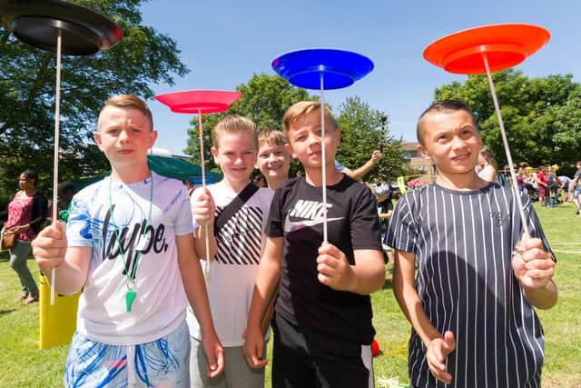 Practicing plate spinning at the Top Banana Circus Skills stall. Picture: Duncan Shepherd