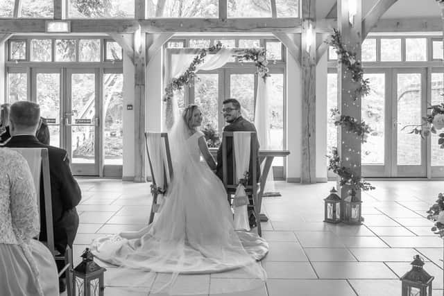 The Dekker-Grays signing their marriage certificate at Riverdale Barn, Yateley.
