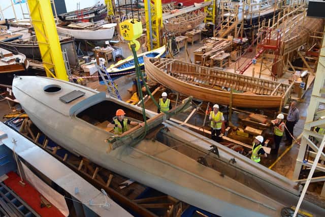 The boat was hoisted up into its new home inside Boathouse 4