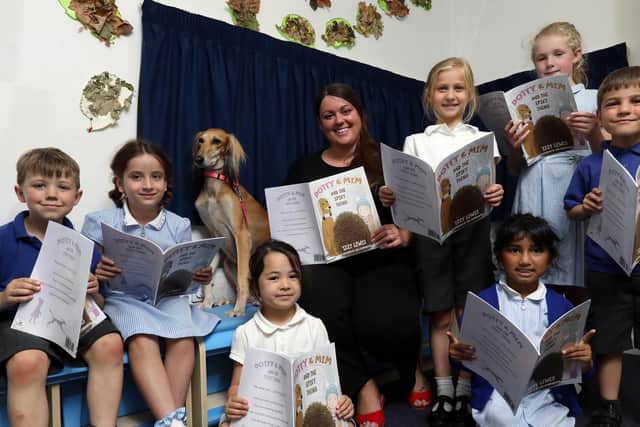 Headteacher Izzy Lewis, with sitting front left, Jemima, four, front right, Naiya, six, then back row, left to right, Buster, five, Sophia, eight, Mim the greyhound, Maya, eight, Katharine, eight, and Theodoras, five  Picture: Chris Moorhouse (260619-39)