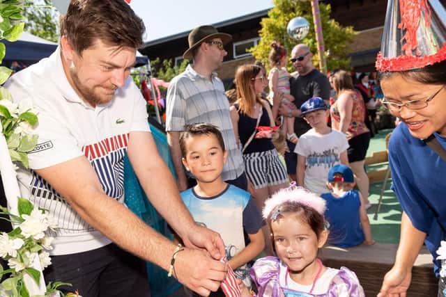 Kieran James, left, running the sweet stall with Oliver, seven, Jessica, four, and mum Noom Mason. Picture: Vernon Nash (290619-006)