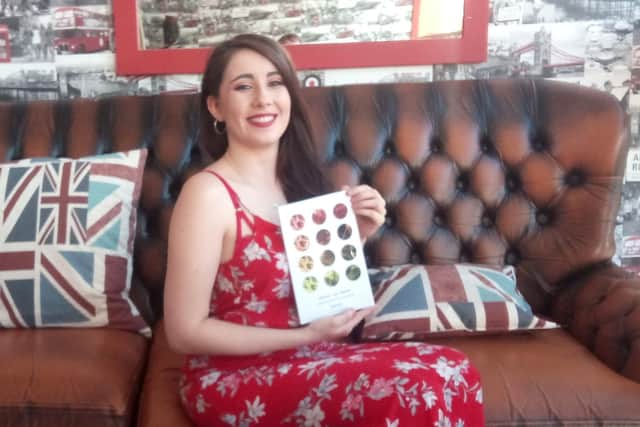 Emily Priest with her new book, Nicotine and Napalm.