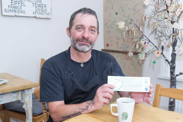 Chris Johnston-Griffiths with one of the vouchers used as a part of the scheme