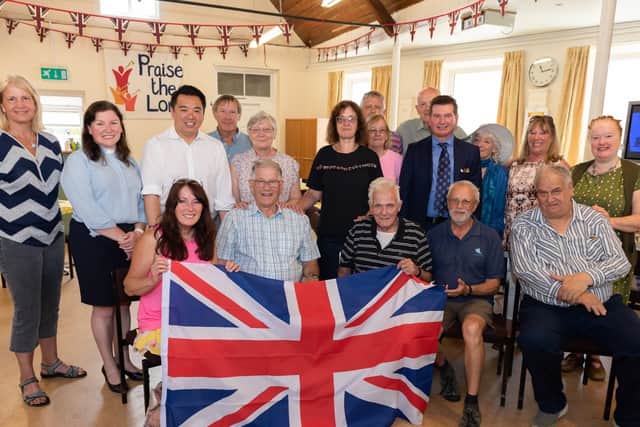 Havant MP, Alan Mak (third from left), handed over a Union Jack flag as part of the church's anniversary.  
Picture: Duncan Shepherd