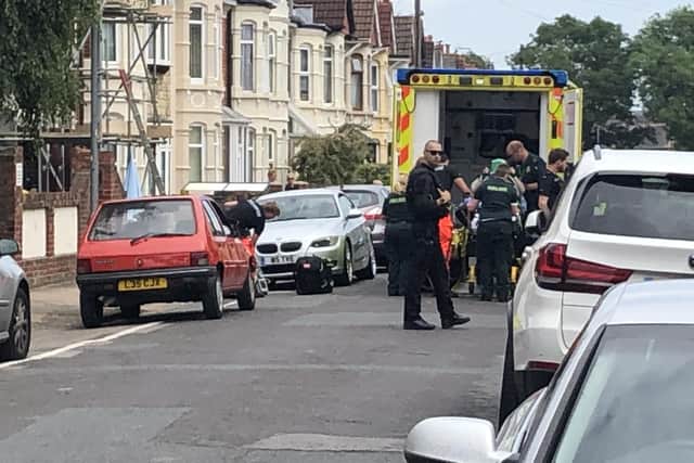 The woman was taken away by paramedics to Queen Alexandra Hospital. Photo: Tom Cotterill