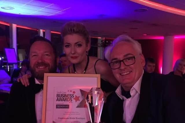 Andrew and Robert Pearce, owners of Creatiques Bridal Boutique, Southsea, with Kayleigh Middleton, assistant manager receiving a previous award.