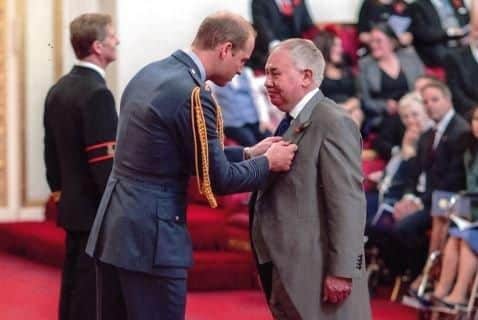 Iain Shepherd receives his MBE from the Duke of Cambridge, Prince William.