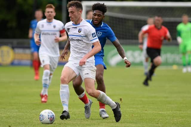 Harrison harries a UCD AFC player on the ball.