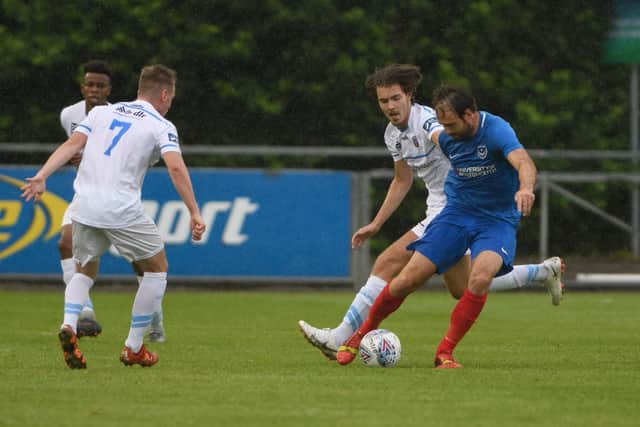 Brett Pitman shields the ball from a tackle