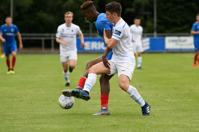 UCD AFC player tries to tackle Lowe