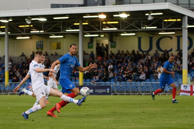 Christian Burgess and Anton Walkes as a UCD AFC player takes a shot