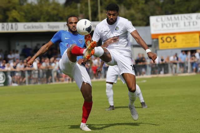 Anton Walkes battles with Hawks' Jonah Ayunga for the ball