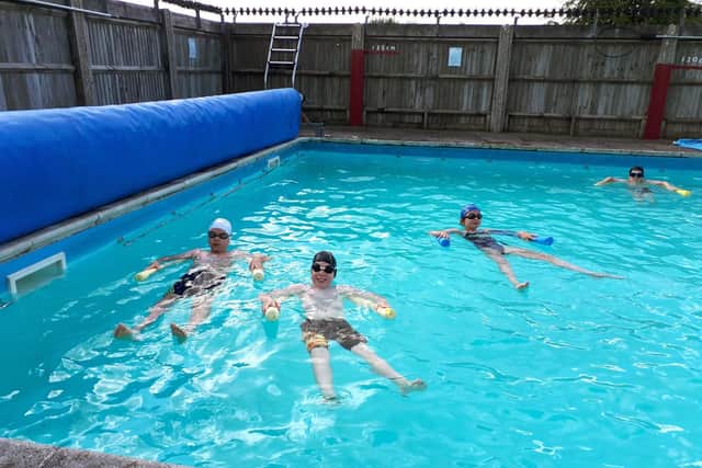 Daniel Jones, Oliver Meadows, Anna Keefe and Aidan Leonard enjoy a swimming lesson at their school pool.