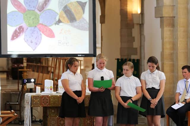Pupils make a presentation during the Leavers Service about the work theyve done at school on conservation of the planet