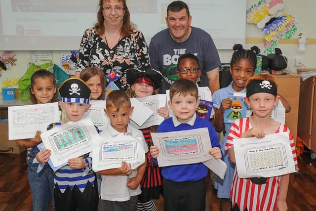 Reading coordinator, Tara Johnston, and Rev Sean Blackman with Grange Infant School pupils who received certificates for reading 100 books in 100 days.
Picture: Habibur Rahman