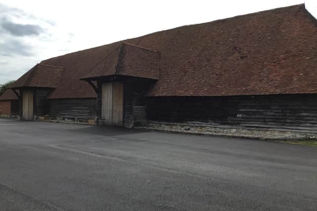 The 15th century barn surrounded by the new tarmac.
