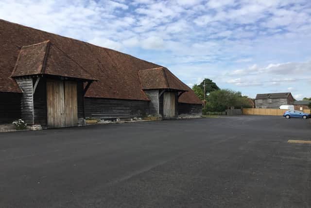 The 15th century barn surrounded by the new tarmac.