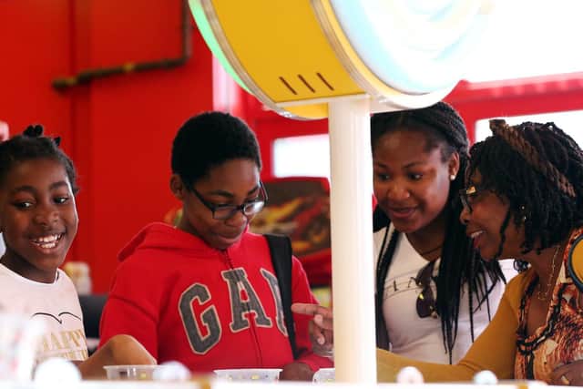Zuleika, 10, left, and her family playing an arcade game. Family fun day at Clarence Pier, organised by Rays of Sunshine. Picture: Chris Moorhouse (130719-3)