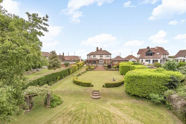 It has landscaped gardens, a panelven kitchen and quadruple garage. It is listed on the market by Henry Adams - Emsworth.