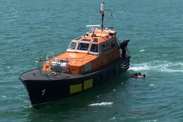 A mother and her two children were rescued in Portsmouth Harbour after being swept out to sea
