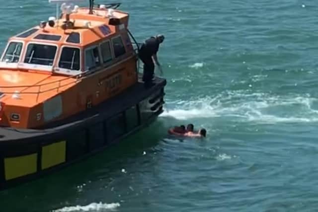 A mother and her two children were rescued in Portsmouth Harbour after being swept out to sea
