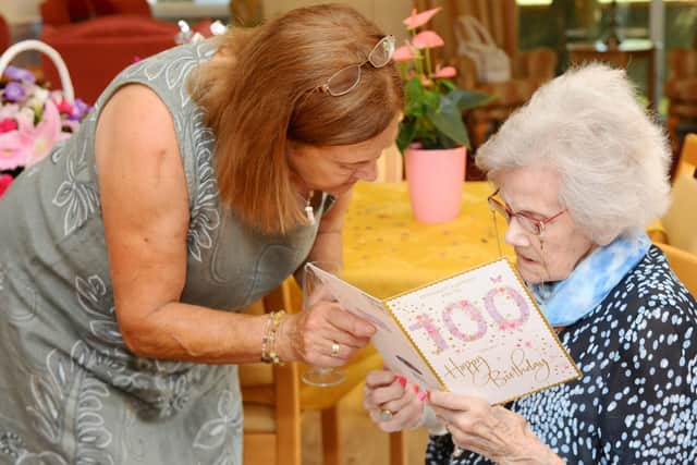 Daughter Sue Wells reads with her mum Stella Edmondson. Picture: Sarah Standing.