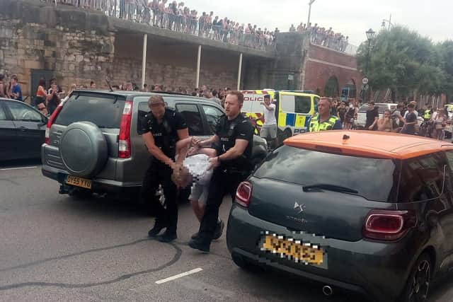 Youths at the Hotwalls in Old Portsmouth on July 25 at around 4.40pm as police are seen making an arrests.