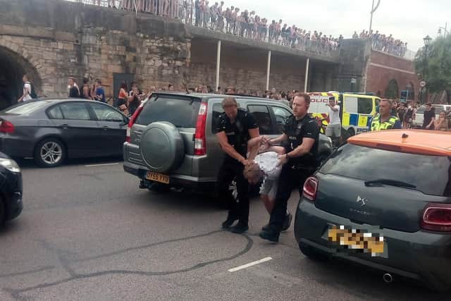 Youths at the Hotwalls in Old Portsmouth on July 25 at around 4.40pm as police are seen making an arrests.