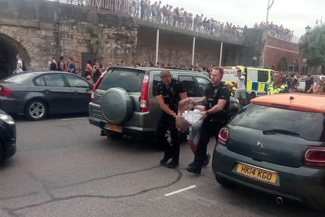 Youths at the Hotwalls in Old Portsmouth on July 25 at around 4.40pm as police are seen making an arrest.