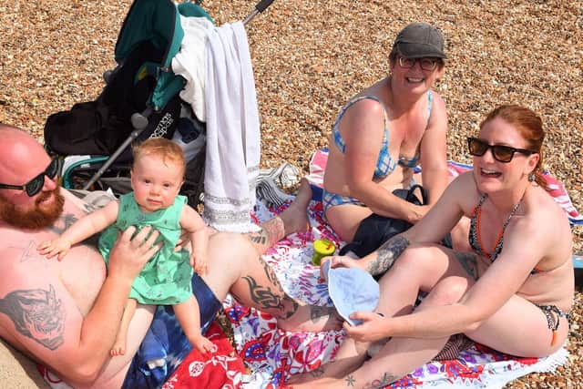 A sunny day out for this Gosport family who were catching far too much sun ! - (left to right) Liam Saunders (33) with baby Roxie Saunders (10 months), Isobel Price and Kelly Saunders (37) - (190725-5078)