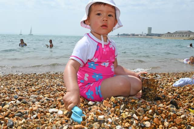 There is very little sand at Old Portsmouth for Holly Turner (30 months) but she was still having great fun filling her pot ! - (190725-4989)