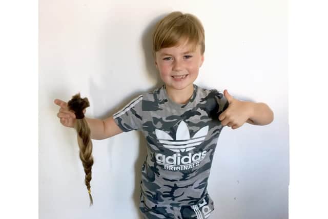 Reuben Bailey, 8, had 17 inches of his hair cut off to donate to the Little Princess Trust