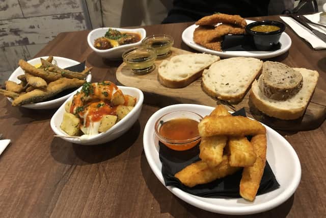 Clockwise from left: Whitebait with saffron mayonnaise, lamb meatballs, chicken katsu, bread and oils, halloumi fries and patatas bravas.