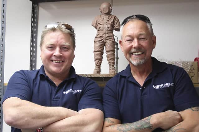 Former Royal Navy clearance divers Paul Guiver and Tony Sexton pictured with a clay model of the diving memorial statuette