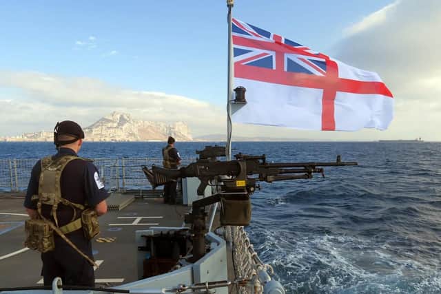 One of HMS Forth's crew stands guard as she approaches Gibraltar for the first time. Photo: Royal Navy