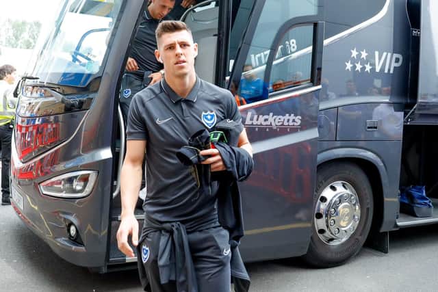 Pompey defender James Bolton (13) arrives at Greenhouse Meadow