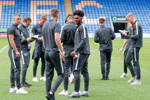Pompey players warm up on the pitch