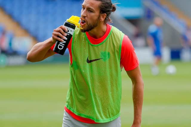 Portsmouth defender Christian Burgess (6) takes a drink of water while warming up