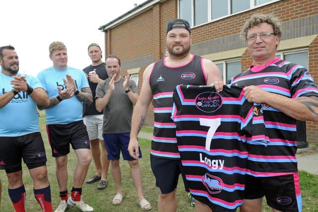 A rugby fun day has been held in Southsea in memory of rugby player Adam Long. His father Ian receives Adam's shirt from organiser Aaron Beasley
Picture: Ian Hargreaves  (030819-5)